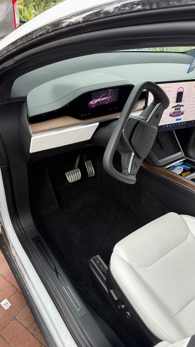 Tesla Model X driver footwell with clean carpet after a Redline Detail interior detail